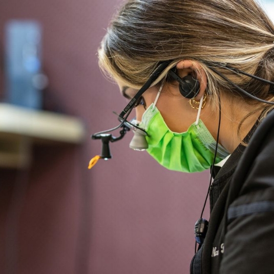Young woman chatting with her dentist during a checkup