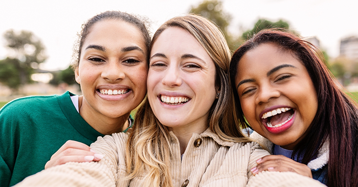 Selfie of three women smiling in the sun after cosmetic dentistry in New Baltimore
