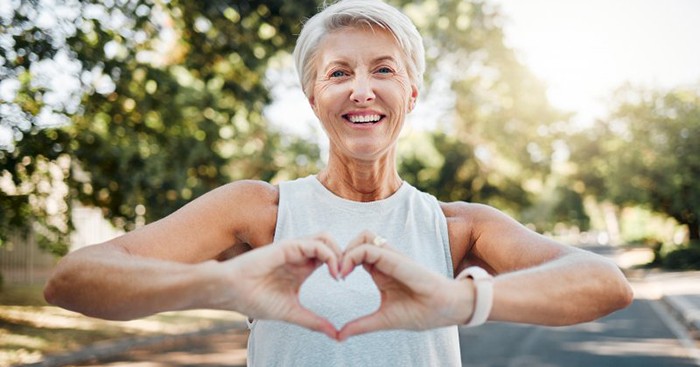 Lady makes shape of heart with her hands