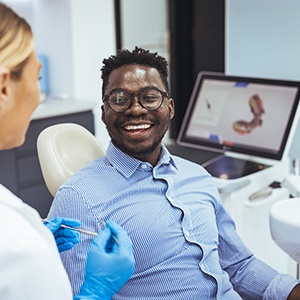 a smiling man speaking to a dentist