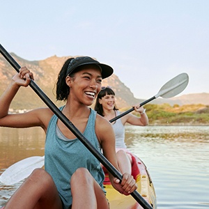 two women kayaking on a lake