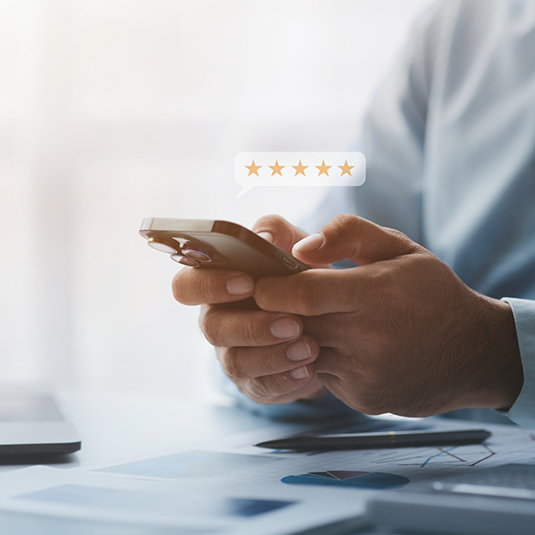 Person leaving a five star review on their phone