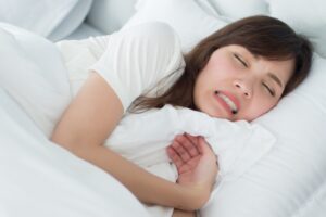 Woman grinding teeth.