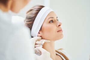 Woman getting a BOTOX injection near her jaw 